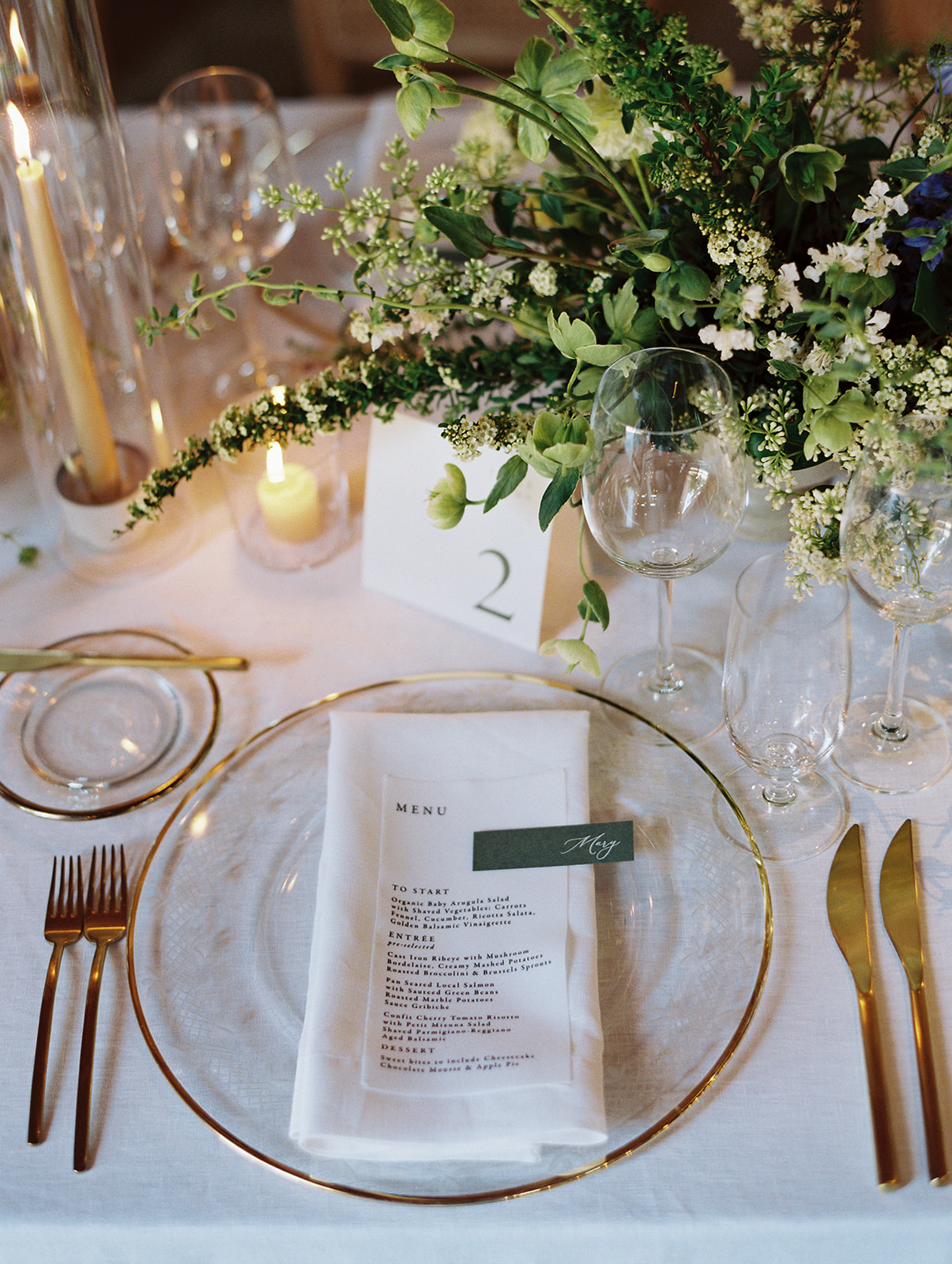 Wedding Tablescape with linen menu and name card, along with table sign and floral arrangement